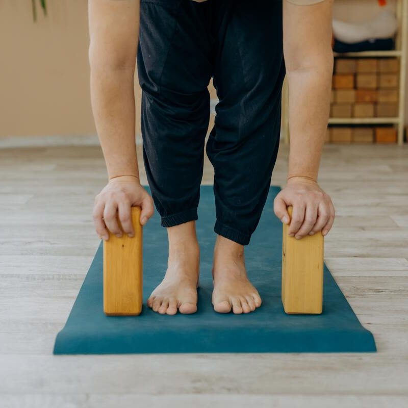 Man doing Pilates with yoga blocks.