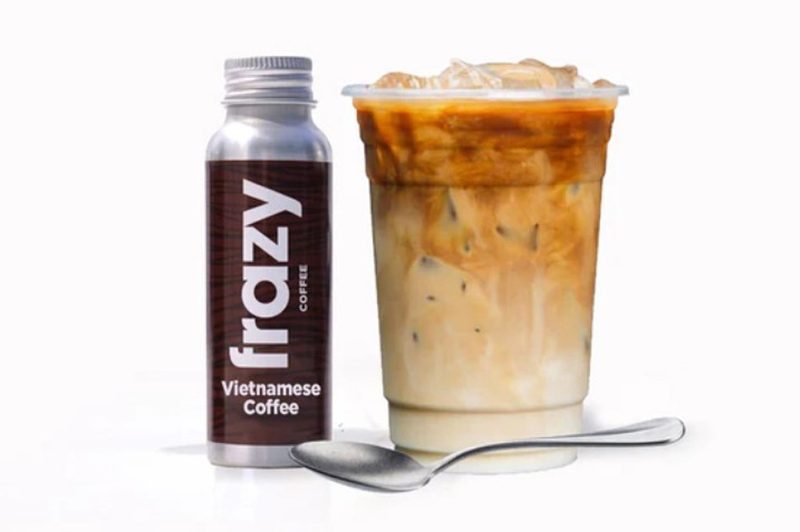 Botlte of Frazy Vietnamese Coffee drink over ice in a cup.