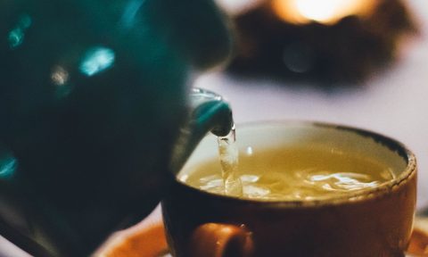 Tea kettle and a cup of green tea