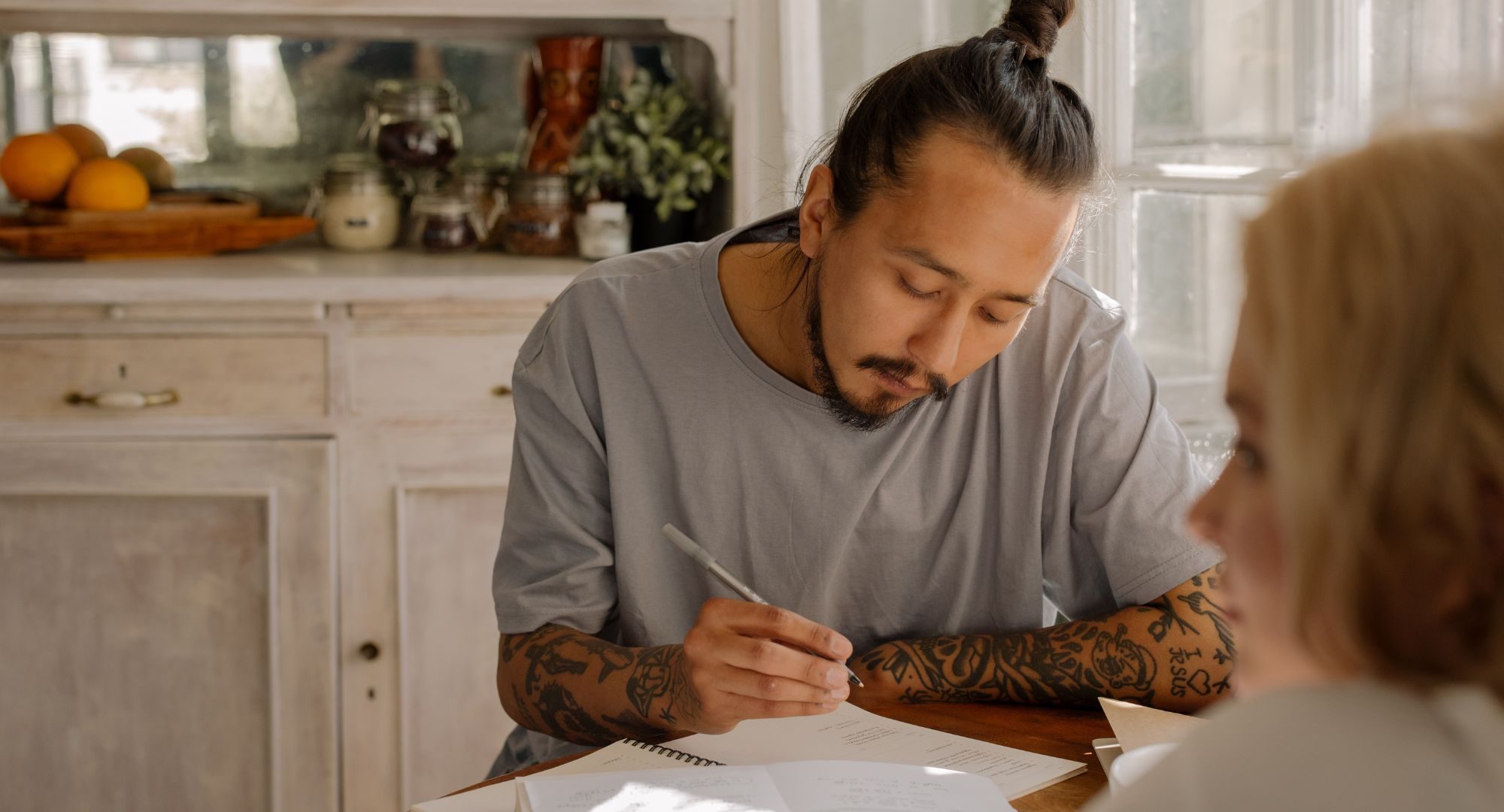 Guy in man bun studying
