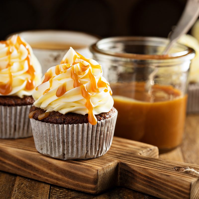Homemade butterscotch cupcakes with caramel syrup and cream cheese frosting