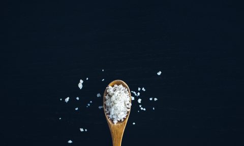 Wooden spoon with large flakes of salt