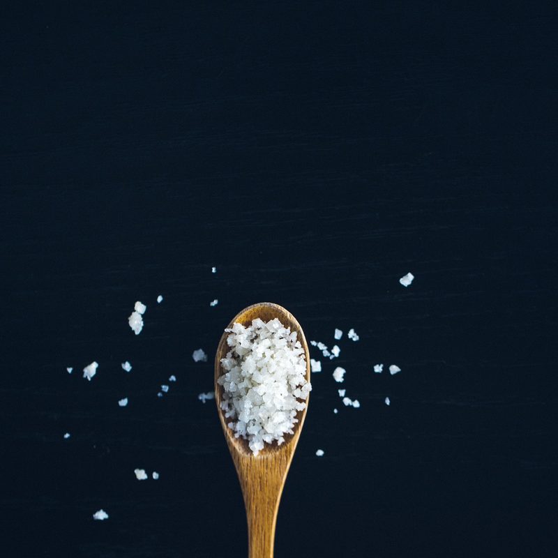 Wooden spoon with large flakes of salt