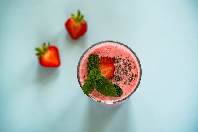 Strawberry smoothie with strawberries on the side