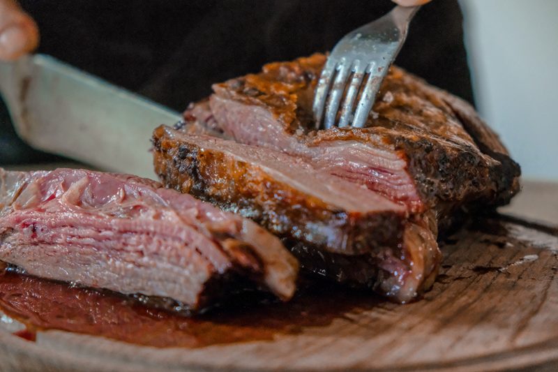 Knife cutting through roast