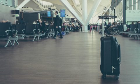 A piece of luggage sitting in the middle of an airport.