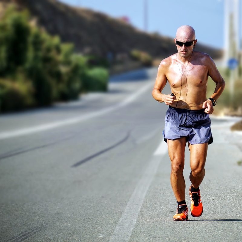 Man jogging on side of road