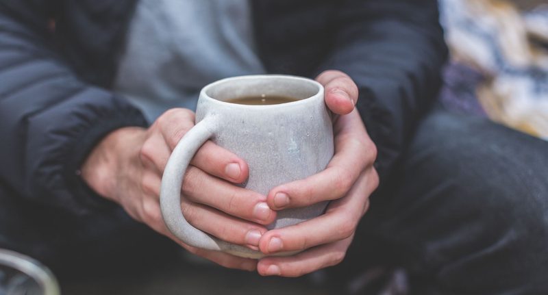 Man holding a warm cup of tea