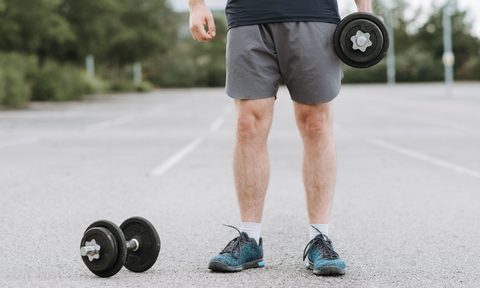 man holding weights outside