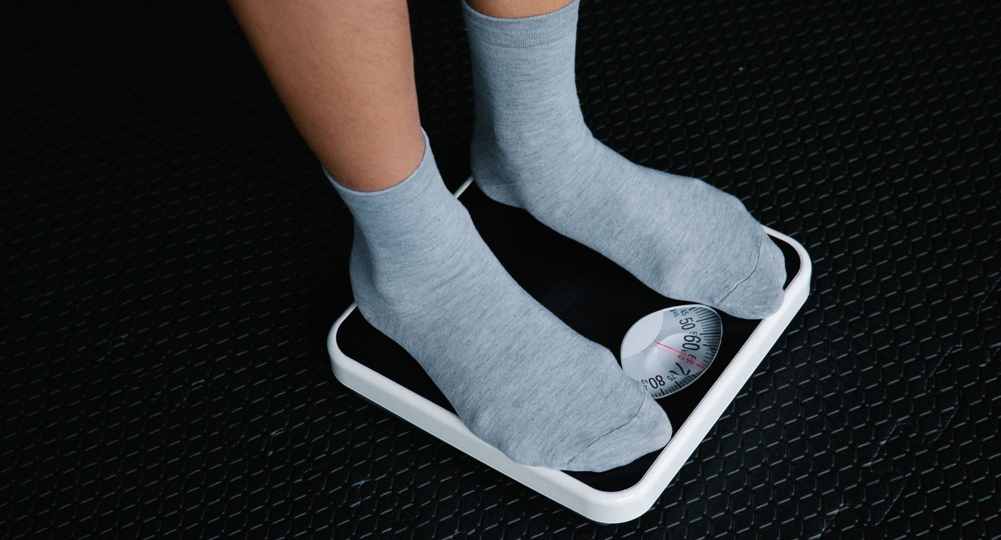 Man in gray socks on scale