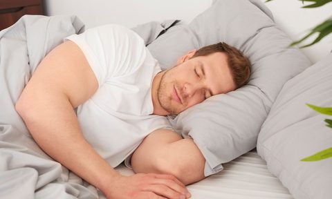 Man sleeping soundly in a white T-shirt