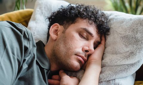 Man sleeping on soft white pillow