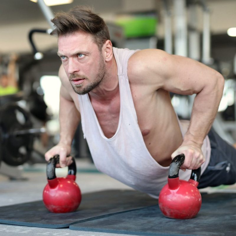 Man working out with red dumbbells