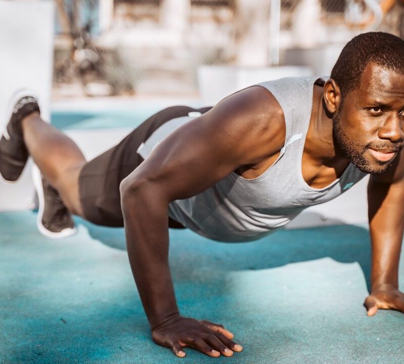 Man doing plank outside