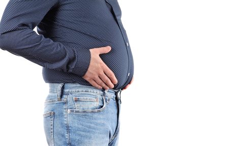 Man with overweight and big fat belly in jeans and shirt