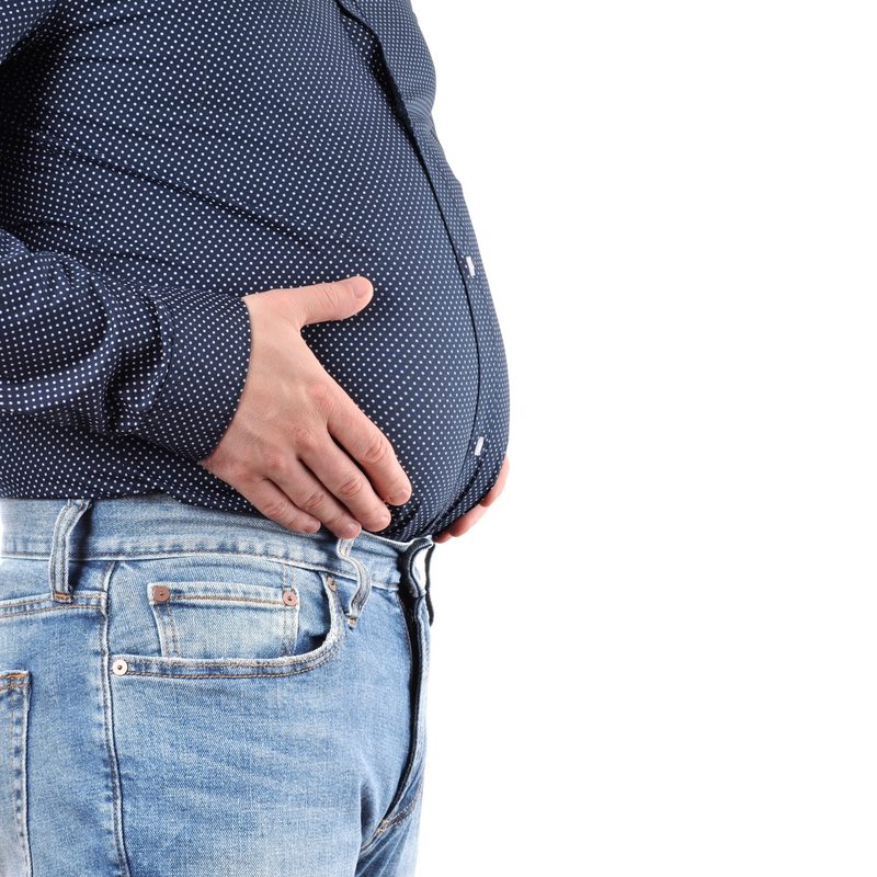 Man with overweight and big fat belly in jeans and shirt