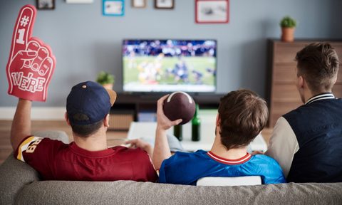 Three men with American football equipment
