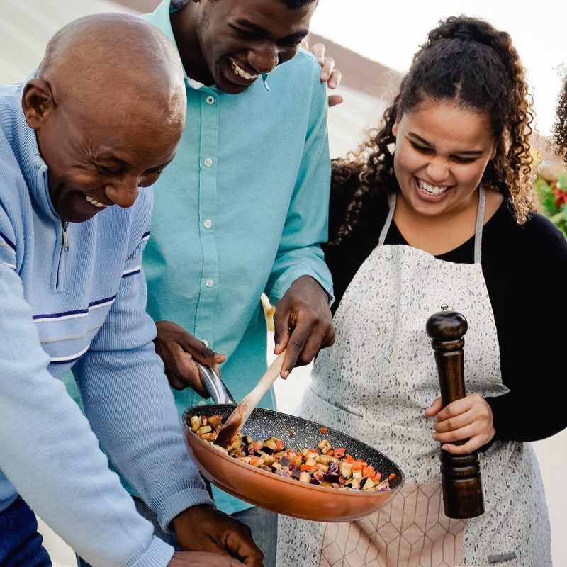 Family cooking together at home on the patio