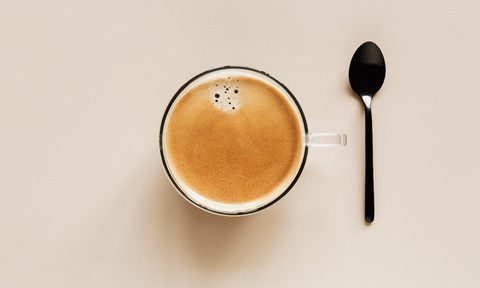 Top view of a cup of coffee with a spoon