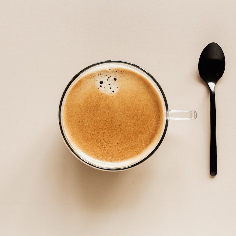 Top view of a cup of coffee with a spoon