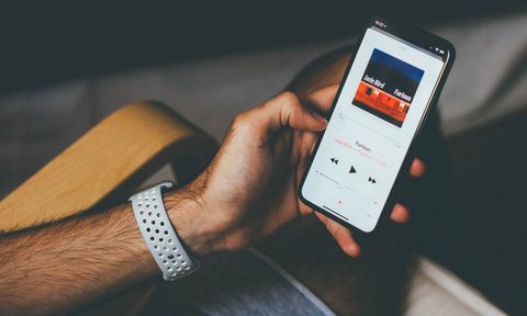 A person listening to music on their iPhone.