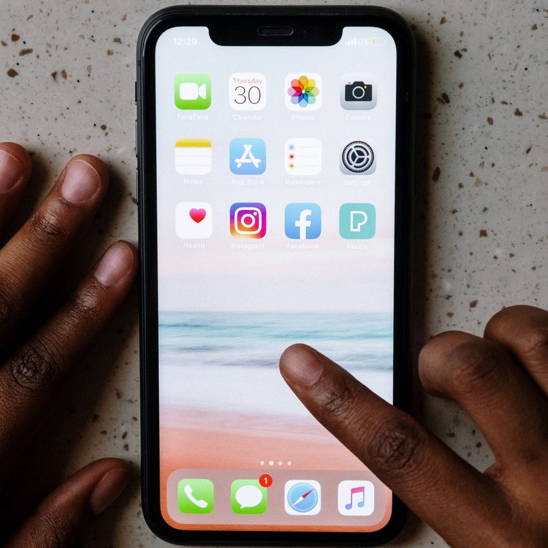 A person going through the settings on their iPhone