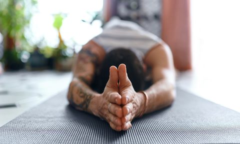 Horizontal view of man's folded hands while doing pilates