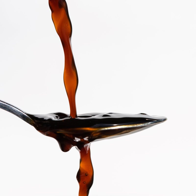 Pouring coconut aminos onto a spoon