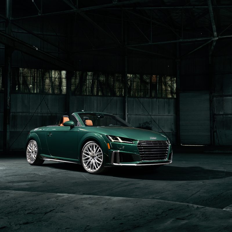 2023 Audi TT Roadster Final Edition right front three-quarter view of the green car with the top down in an empty warehouse
