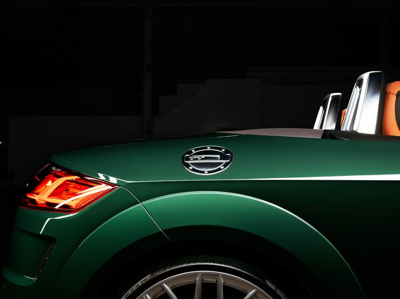 2023 Audi TT Roadster Final Edition view across the right rear quarter panel of the green car in an empty warehouse.