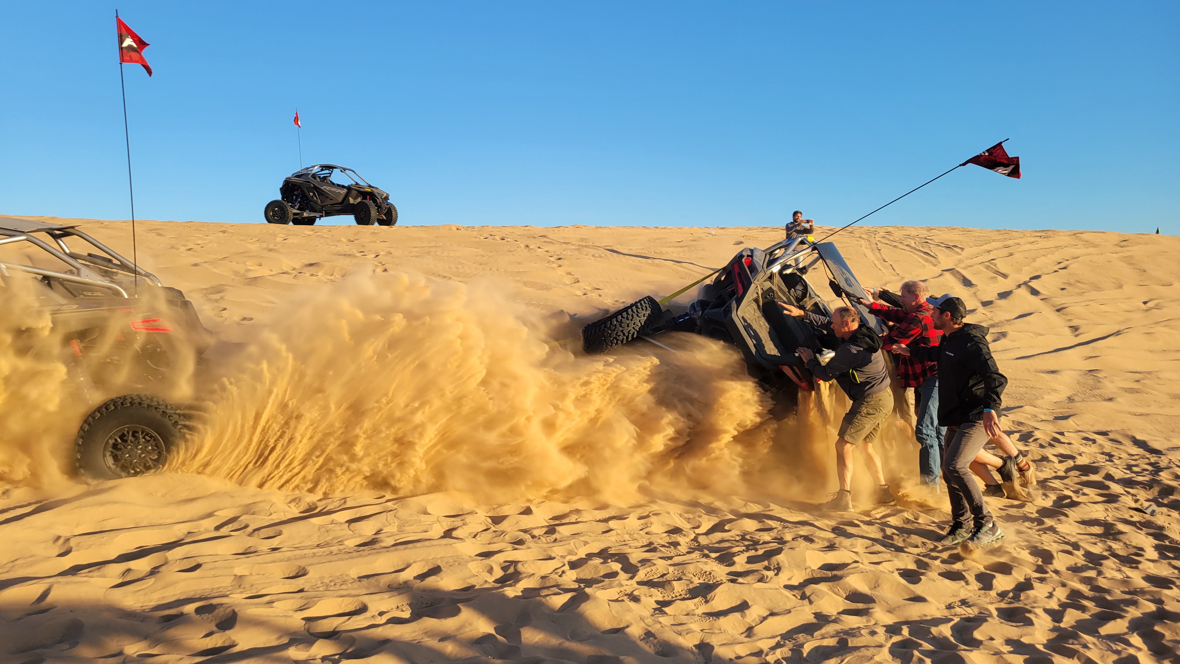 A group of people righting a flipped side by side
