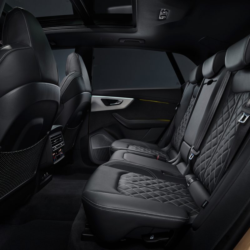 2024 Audi Q8 55 TFSI in Sakhir Gold interior back seat view from the drivers side -- European Model Shown.