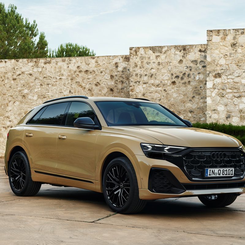 2024 Audi Q8 55TFSI in Sakhir Gold left front three-quarter view - European Model Shown.