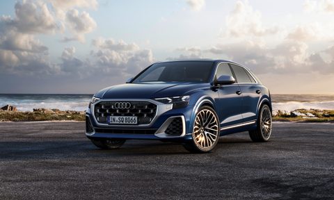 2024 Audi S Q8 in Waitomo Blue left front three-quarter view on pavement near the ocean shore - European Model Shown..