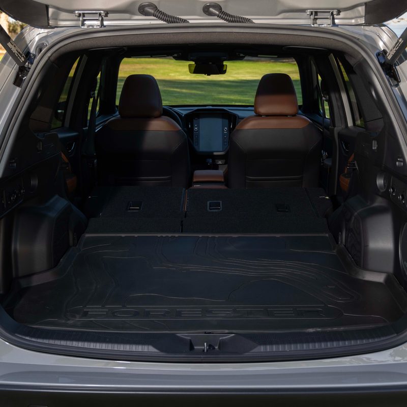 2025 Subaru Forester rear view wiht hatch open showing flat floor from behind first row seats.