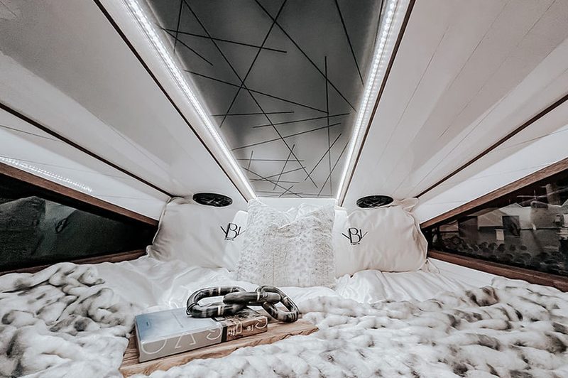 Sleeping quarters with a king-sized bed inside the 27North F550 Ascender truck camper.