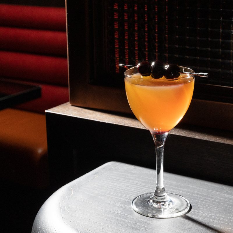 Black Manhattan cocktail on a table