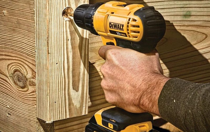 A DeWALT drill bearing into wood.