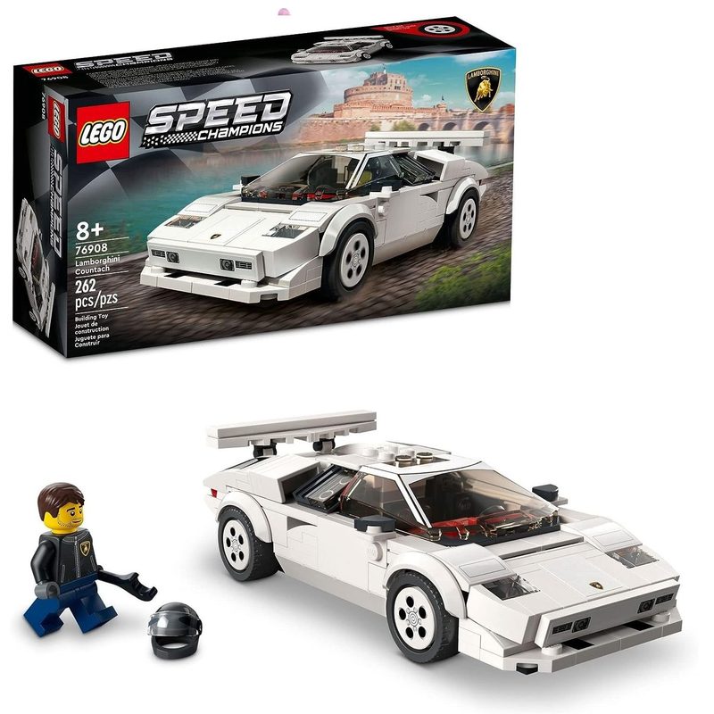 A Lego Lamborghini Countach with associated driver in front of its box.