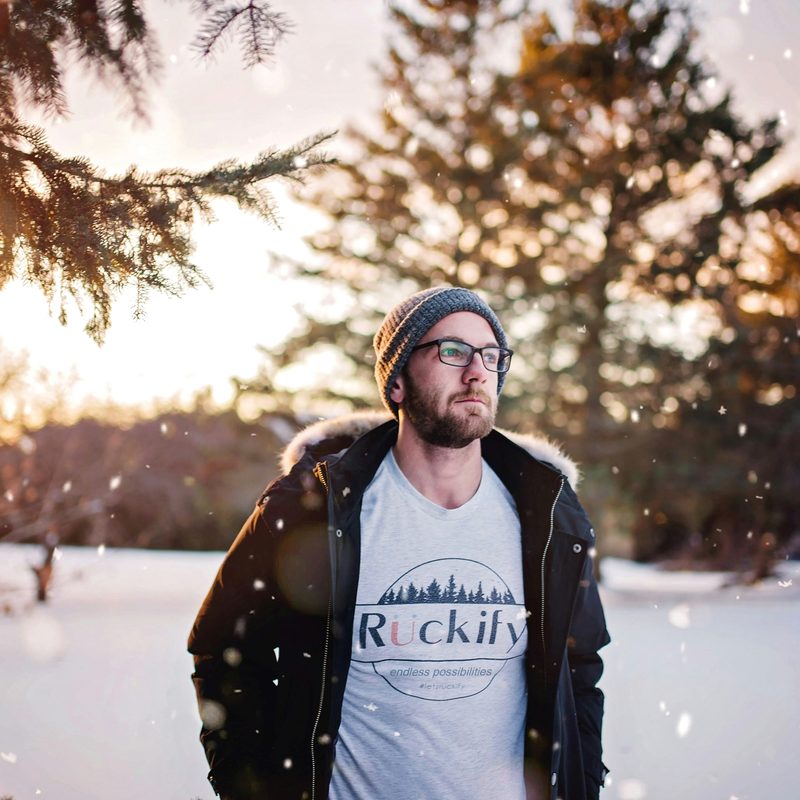 Man in the snow wearing a beanie