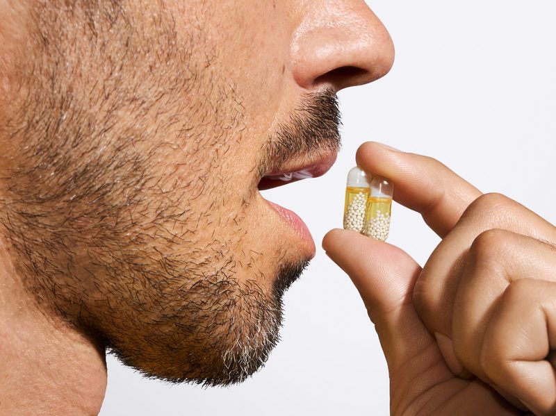 Man taking Ritual Essential multivitamin capsule