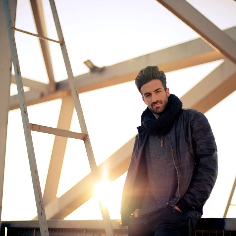 Man wearing scarf in sunset