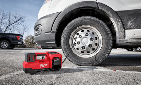 Someone using a Milwaukee M18 Inflator on Van