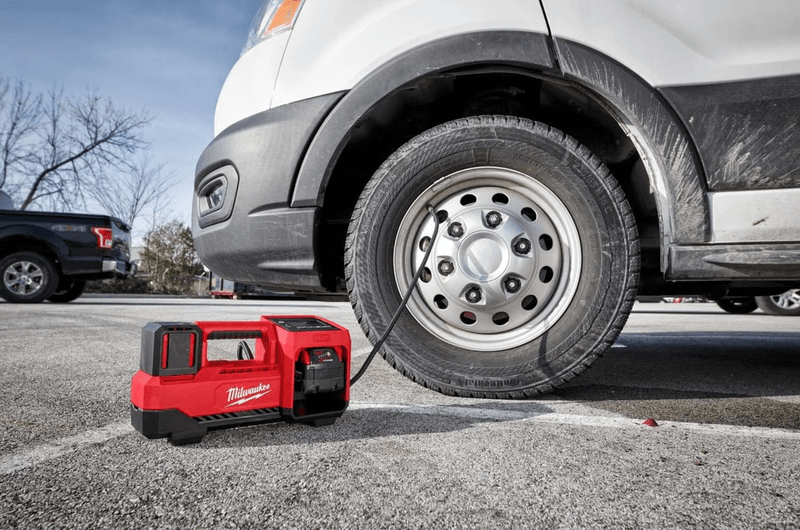 Someone using a Milwaukee M18 Inflator on Van