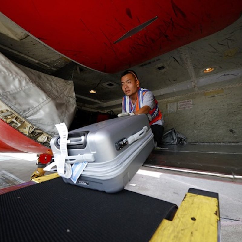 A Southwest Airlines employee loads luggage into the plane cargo