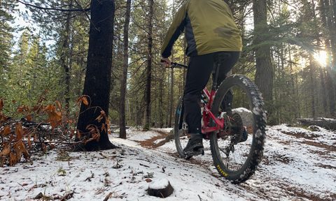 Riding up a snowy trail in Trew Gear's Up Jack windbreaker