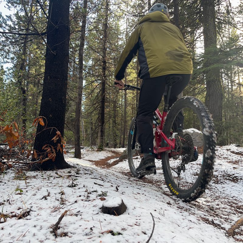 Riding up a snowy trail in Trew Gear's Up Jack windbreaker