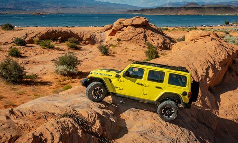 Yellow 2024 Jeep Wrangler Rubicon X4e rock climbing at a state park in Utah.
