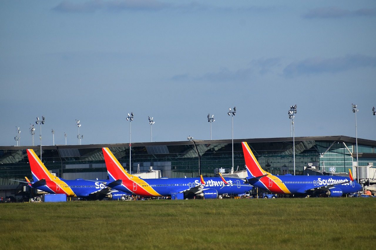 Multiple Southwest Airlines planes lined up at an airport outside