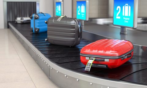 Baggage claim in airport terminal. Suitcases on the airport luggage conveyor belt.